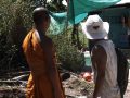 Monk with coordinator observing renovation activities by participants